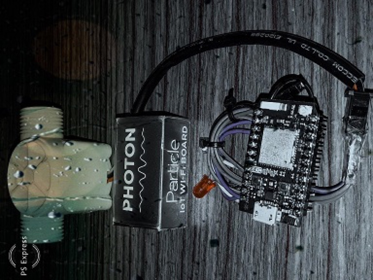 Particle Photon wired to a water flow sensor and status LED on a breadboard